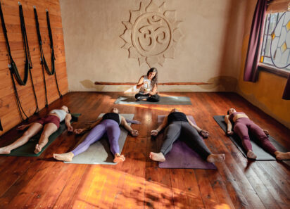 Yoga class lying down in in Corpse pose. Shavasana at end of class. Final pose of yoga class deep restoration, body and mind relaxation concept